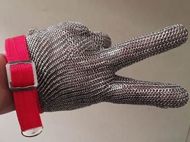 A hand is wearing a piece of stainless steel chainmail glove with silver white metal buckle.