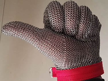 A hand wearing a silver white chainmail glove is making a gesture of great.